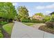 Long concrete driveway leading to a beautifully landscaped property with mature trees at 2017 Harts Mill Ne Rd, Chamblee, GA 30341