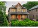 Lovely brick home with a covered porch and beautifully manicured hedges at 2017 Harts Mill Ne Rd, Chamblee, GA 30341