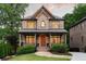Charming two-story brick home featuring a covered front porch and manicured landscaping at 2017 Harts Mill Ne Rd, Chamblee, GA 30341