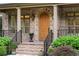 Charming front entrance featuring a wooden door, brick steps, and manicured greenery at 2017 Harts Mill Ne Rd, Chamblee, GA 30341
