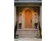 Close-up of the front door showcasing its unique arched design and exterior lighting at 2017 Harts Mill Ne Rd, Chamblee, GA 30341