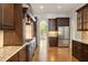 Modern kitchen features dark wood cabinets, stainless steel appliances, granite countertops and hardwood floors at 2017 Harts Mill Ne Rd, Chamblee, GA 30341