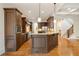 Open-concept kitchen features a large island, stainless steel appliances, and dark wood cabinetry at 2017 Harts Mill Ne Rd, Chamblee, GA 30341