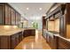 Gourmet kitchen with custom dark wood cabinets, granite countertops, and hardwood floors at 2017 Harts Mill Ne Rd, Chamblee, GA 30341