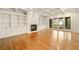 Bright living room with hardwood floors, built-in shelving, fireplace, and sliding glass doors leading to the outdoors at 2017 Harts Mill Ne Rd, Chamblee, GA 30341
