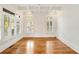 Bright living room with hardwood floors, white walls, and large windows with shutter style blinds at 2017 Harts Mill Ne Rd, Chamblee, GA 30341