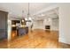 Open-concept living room featuring hardwood floors, coffered ceilings, fireplace, and access to the kitchen and stairway at 2017 Harts Mill Ne Rd, Chamblee, GA 30341
