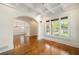 Bright living room boasts hardwood floors, coffered ceilings, and large windows with shutter style blinds at 2017 Harts Mill Ne Rd, Chamblee, GA 30341