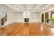 Spacious living room with coffered ceilings, fireplace, built-in shelving, and sliding glass doors at 2017 Harts Mill Ne Rd, Chamblee, GA 30341