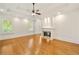 Bright living room with a fireplace, hardwood floors, natural light, and tray ceilings at 2017 Harts Mill Ne Rd, Chamblee, GA 30341