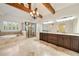 Bright main bathroom with vaulted ceiling, wooden beams, soaking tub, glass shower, and double vanity at 2017 Harts Mill Ne Rd, Chamblee, GA 30341