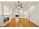 Bright bedroom with a fireplace, hardwood floors, tray ceiling, and ceiling fan at 2017 Harts Mill Ne Rd, Chamblee, GA 30341