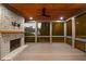 Cozy screened-in porch with a brick fireplace, wood-paneled ceiling, and ample natural light from surrounding windows at 2017 Harts Mill Ne Rd, Chamblee, GA 30341
