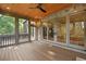 Spacious screened-in porch with wood flooring, a brick fireplace, and access to the interior through sliding glass doors at 2017 Harts Mill Ne Rd, Chamblee, GA 30341
