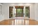 Living room showcasing sliding glass doors leading to a screened-in porch with a fireplace and ceiling fan at 2017 Harts Mill Ne Rd, Chamblee, GA 30341