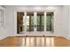 Living room featuring sliding glass doors to a screened porch with brick fireplace and wood-paneled ceiling at 2017 Harts Mill Ne Rd, Chamblee, GA 30341