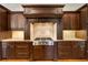 Close up on a kitchen range with dark wood cabinets and granite countertops at 2017 Harts Mill Ne Rd, Chamblee, GA 30341