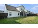 Exterior view of the home's backyard featuring the patio and lawn at 35 Henson Farm Dr, Loganville, GA 30052