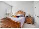 Cozy bedroom featuring natural light, carpet, and a decorative headboard at 35 Henson Farm Dr, Loganville, GA 30052