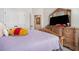 Inviting bedroom showcases a decorative dresser, television, and plush carpet at 35 Henson Farm Dr, Loganville, GA 30052