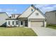Charming single Gathering home featuring a two-car garage and manicured lawn at 35 Henson Farm Dr, Loganville, GA 30052