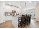 Bright kitchen with white cabinets, granite counters, and a kitchen island with seating at 35 Henson Farm Dr, Loganville, GA 30052