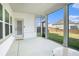 Screened-in back patio with views of the fenced backyard and adjacent homes at 35 Henson Farm Dr, Loganville, GA 30052