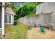 A tranquil backyard featuring a stone wall, garden bench, and a mix of gravel and grass at 3765 Windsor Cir, Clarkston, GA 30021