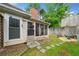 A cozy backyard with a screened porch, stone path, and retaining wall at 3765 Windsor Cir, Clarkston, GA 30021