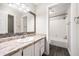 Bathroom featuring a vanity with ample counter space, a mirror, and a tiled shower-tub combo at 3765 Windsor Cir, Clarkston, GA 30021