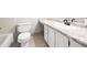 Bright bathroom featuring a toilet, white vanity with a light countertop, and a large mirror at 3765 Windsor Cir, Clarkston, GA 30021