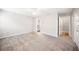 Large bedroom with plush carpeting, a ceiling fan, and views to an en-suite bathroom and closet at 3765 Windsor Cir, Clarkston, GA 30021