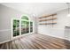 Bright dining room featuring wood floors, crown molding, and a large window providing ample natural light at 3765 Windsor Cir, Clarkston, GA 30021