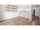 Open-concept dining area with wood floors and a view into the modern kitchen featuring stainless steel appliances at 3765 Windsor Cir, Clarkston, GA 30021