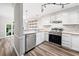 Well-lit kitchen with stainless steel appliances, light countertops, open shelving, and modern track lighting at 3765 Windsor Cir, Clarkston, GA 30021