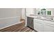 Bright kitchen featuring stainless steel appliances, light granite countertops, and wood-look flooring at 3765 Windsor Cir, Clarkston, GA 30021