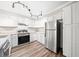 Modern kitchen features stainless steel appliances, white cabinets, and stylish track lighting at 3765 Windsor Cir, Clarkston, GA 30021