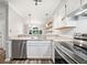 This spacious kitchen has stainless steel appliances, granite countertops, open shelving, and bright lighting at 3765 Windsor Cir, Clarkston, GA 30021