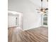 Open-concept living room with a ceiling fan, high ceilings, and large windows for plenty of natural light at 3765 Windsor Cir, Clarkston, GA 30021