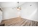 Bright living room with high ceilings, ceiling fan, wood-look flooring, and neutral paint at 3765 Windsor Cir, Clarkston, GA 30021