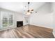 Bright living room has a fireplace, ceiling fan, high ceilings, and large windows at 3765 Windsor Cir, Clarkston, GA 30021