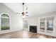 Spacious living room with vaulted ceilings, a ceiling fan, fireplace, and large windows at 3765 Windsor Cir, Clarkston, GA 30021