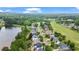 Residential street aerial view overlooking beautiful pond, lush golf course, and wooded terrain at 5375 Glenhaven Dr, Cumming, GA 30041