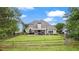 Expansive backyard with lush green grass, wood fence, and a covered patio great for relaxing at 5375 Glenhaven Dr, Cumming, GA 30041