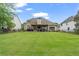 Large, well-maintained backyard with a wood fence and a covered patio for outdoor entertaining at 5375 Glenhaven Dr, Cumming, GA 30041