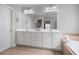 Bathroom with a large white vanity, double sinks, and a soaking tub at 5375 Glenhaven Dr, Cumming, GA 30041