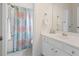 Bathroom featuring a shower with colorful shower curtain and white vanity with mirror at 5375 Glenhaven Dr, Cumming, GA 30041