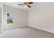 Bright bedroom with neutral paint, carpet, and a large window allowing for ample natural light at 5375 Glenhaven Dr, Cumming, GA 30041