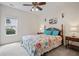 Cozy bedroom featuring a colorful bedspread, soft carpet and great natural light from the window at 5375 Glenhaven Dr, Cumming, GA 30041