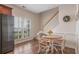 Eat-in kitchen with a round table, stainless steel refrigerator, wood floors and shuttered windows at 5375 Glenhaven Dr, Cumming, GA 30041